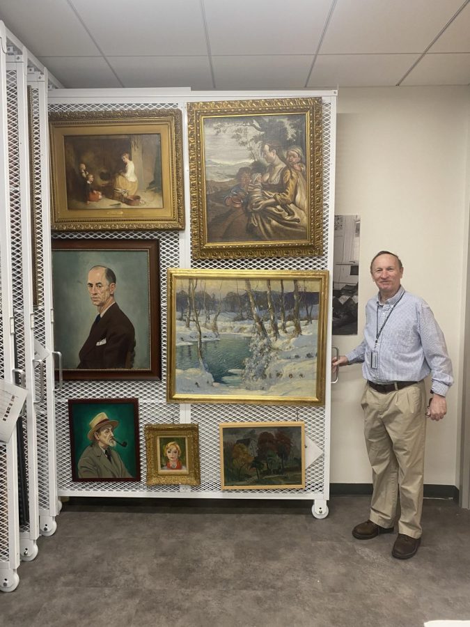 Dr. Harpaz showcasing some paintings