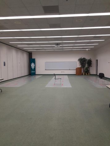 Image of COVID-19 testing center at the Des Plaines campus. A spacious room with plastic coverings over flooring areas.